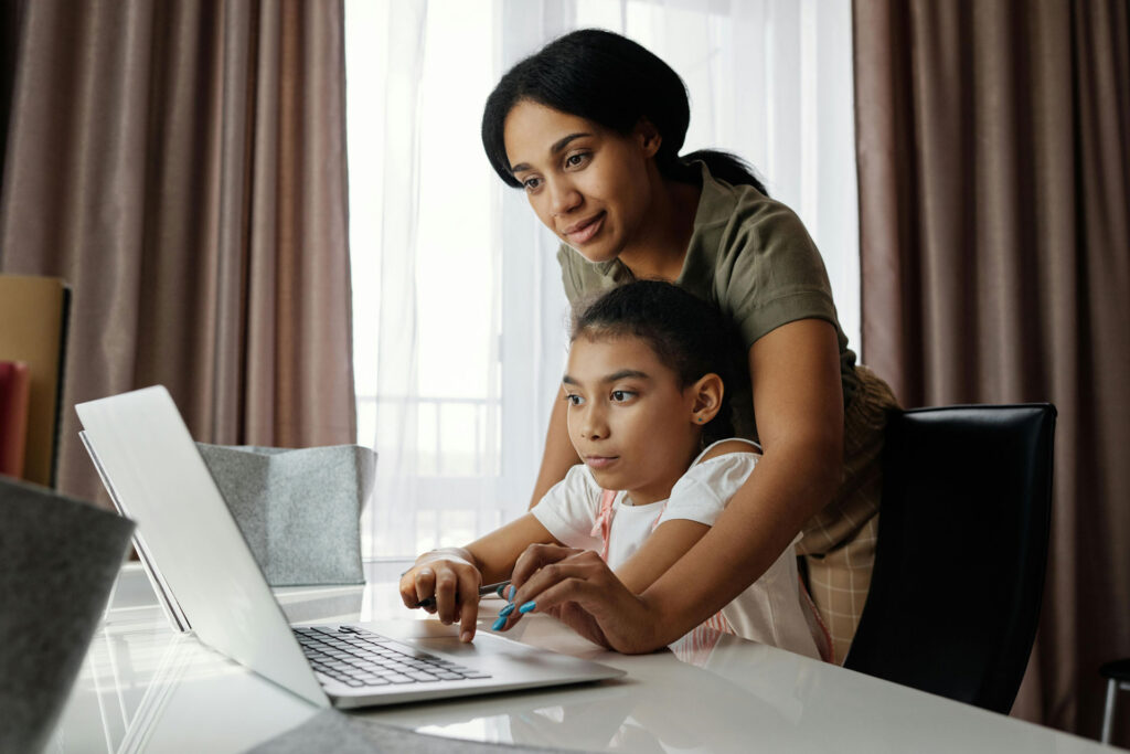 Parent or Guardian with student using laptop