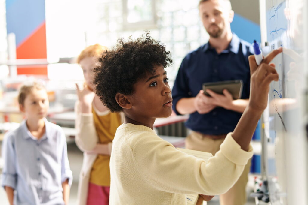 4th grader working on white board